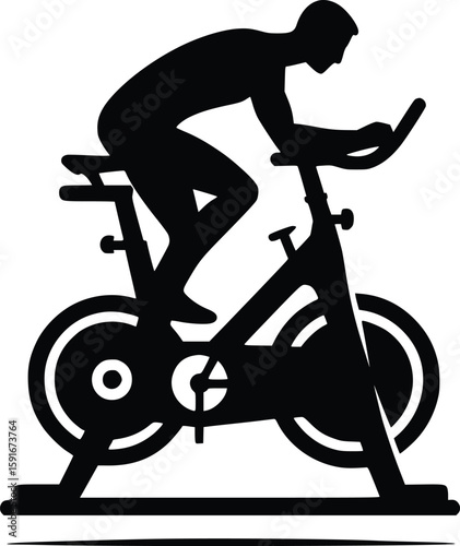 Silhouette of a person riding a stationary exercise bicycle indoors