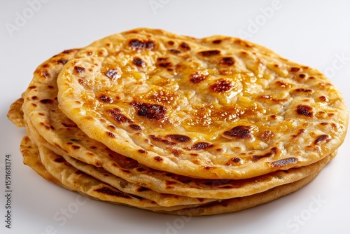 Delicious puran poli flatbread with jaggery served on a clean white background showcasing traditional Indian cuisine