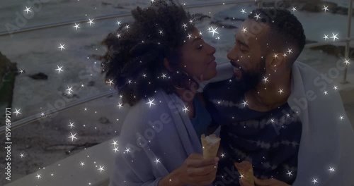 Couple sitting bench locking eyes leaning in sharing cones with star overlay celebrating dating