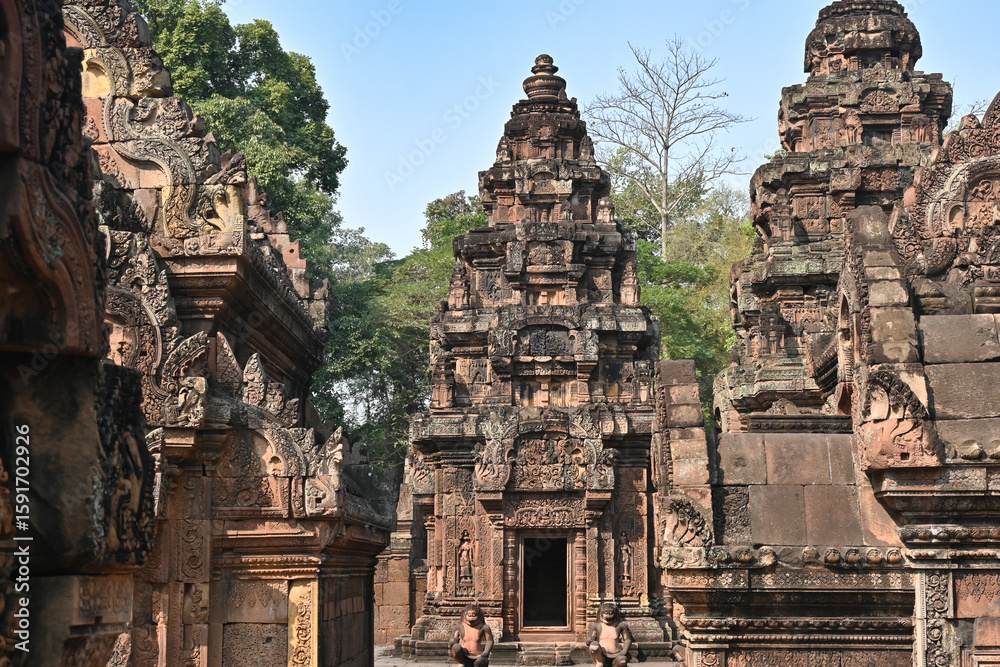 Naklejka premium Ancient temple complex with richly decorated stone towers and carvings, showcasing traditional Southeast Asian religious architecture.