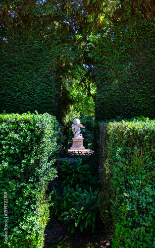 Monumento al Tempo, The Monument of Time is surrounded by the foliage of luxurious trees in the rays of the sun in Villa Barbarigo Valsanzibio Padua Galzignano Terme.