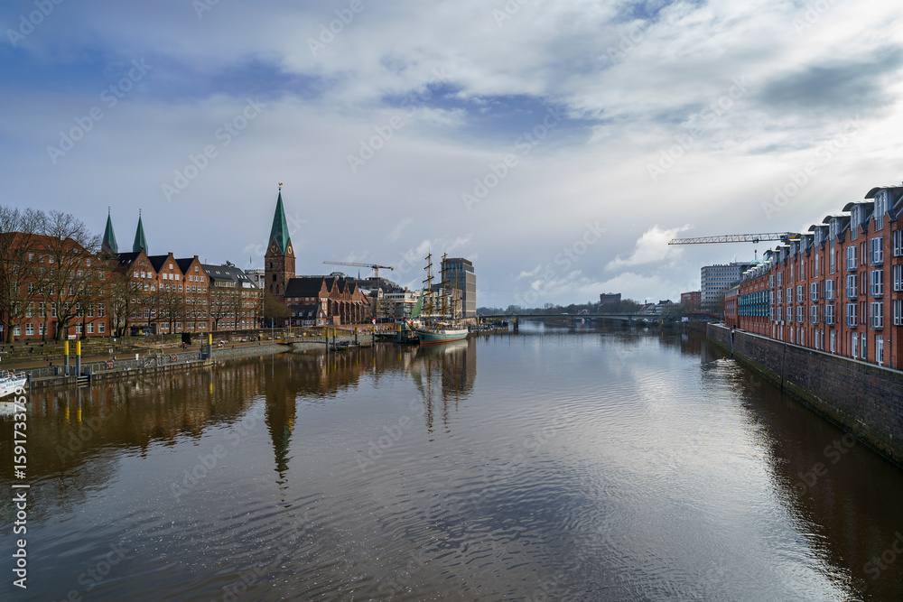 Fototapeta premium Bremen’s skyline shines after the storm, as seen from the Weser Bridge, Germany