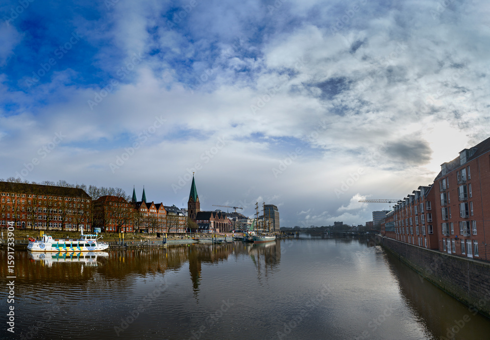 Naklejka premium Bremen’s skyline shines after the storm, as seen from the Weser Bridge, Germany