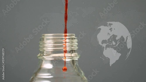 Single red droplet appearing above glass bottle neck, merging into stream filling bottle