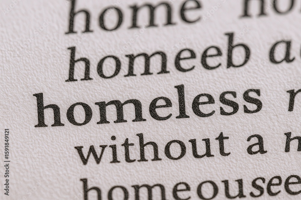 Obraz premium Close-up of black bold text on white paper showing the word homeless among other words.