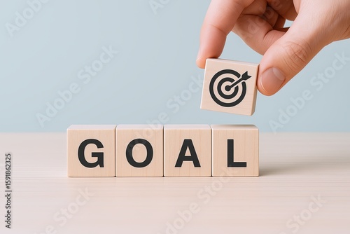 Hand placing a wooden block with a target symbol next to 