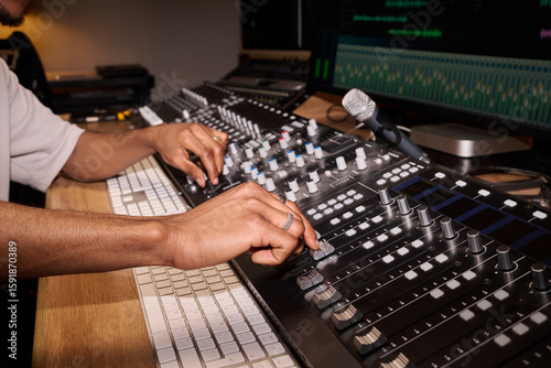 Konstfotografi Young adult Black man adjusting audio mixing console in professional recording s