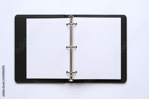 Wallpaper Mural Open black notebook with lined pages and silver rings lying flat on a white surface. Torontodigital.ca