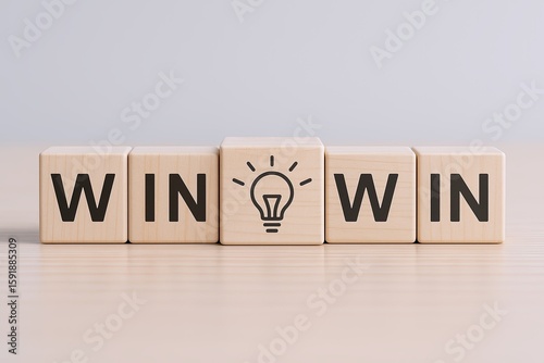 Wooden blocks spelling WIN with a light bulb icon representing ideas or innovation.