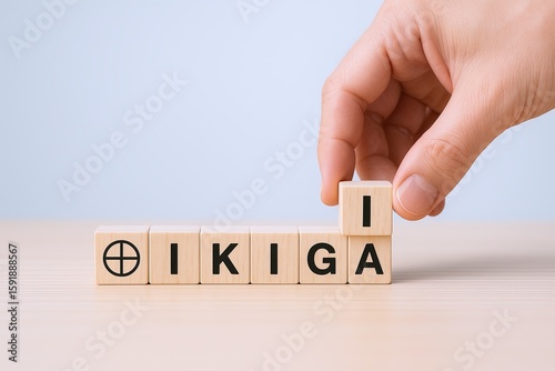 Hand arranging wooden letter tiles spelling 