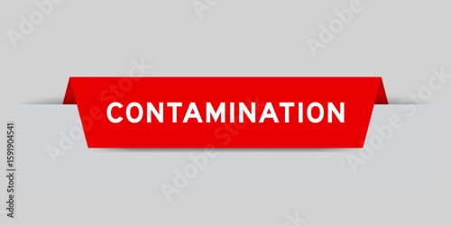 Red color inserted label with word contamination on gray background