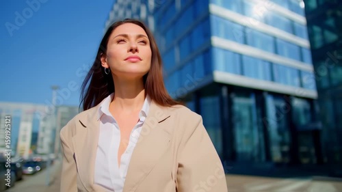 Confident Businesswoman Reflects in Modern Cityscape