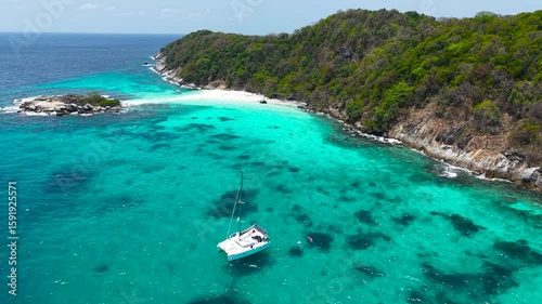 Beautiful deserted secluded island with turquoise water off the coast. Dreamy yacht trip around the islands