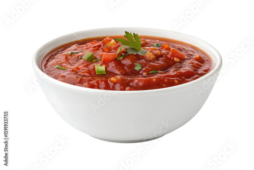 Red salsa with chopped tomatoes and green herbs in a white bowl image