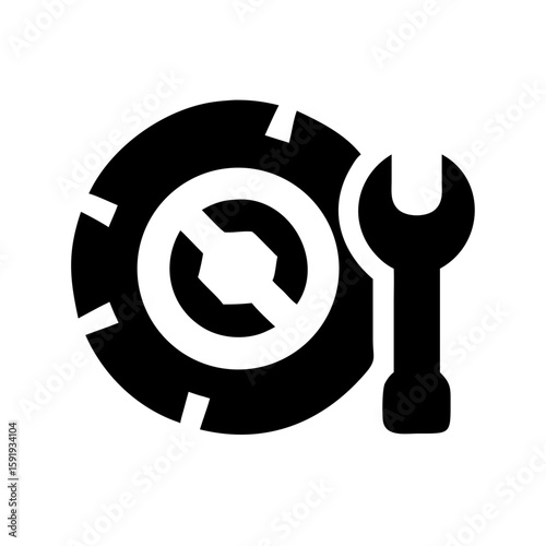 Car tire with a wrench for vehicle maintenance and repair services. Car tire is placed near adjustable spanner to show automobile service, mechanical work and car care.