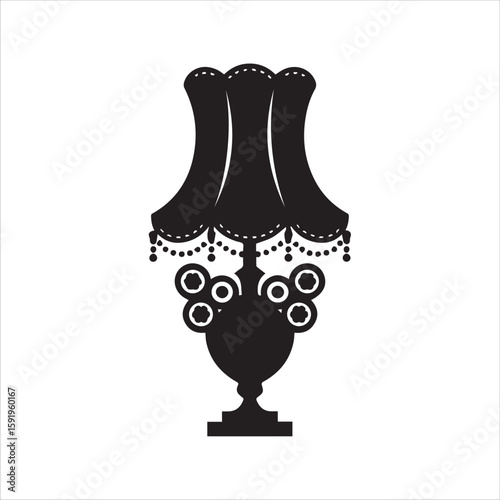 Elegant black silhouette of a vintage ornate table lamp with a fringed lampshade