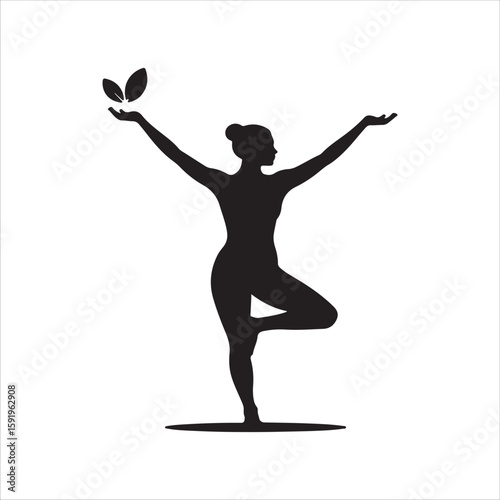 Silhouette of a woman in a yoga tree pose with leaves in her hand