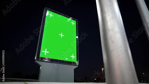 Vertical Digital Billboard with Green Screen and Tracking Markers at Night in Urban Setting, Ready for Advertisement or Information Display Mockup