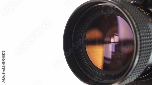 Lens of vintage Super 8 movie camera on white background.Old film camera.Close up
