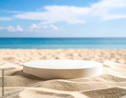 Empty white pedestal on sandy beach