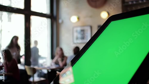 Wallpaper Mural Green Screen Laptop Displayed in a Modern Cafe Environment, Ideal for Digital Content Creation and Chroma Key Compositing Torontodigital.ca