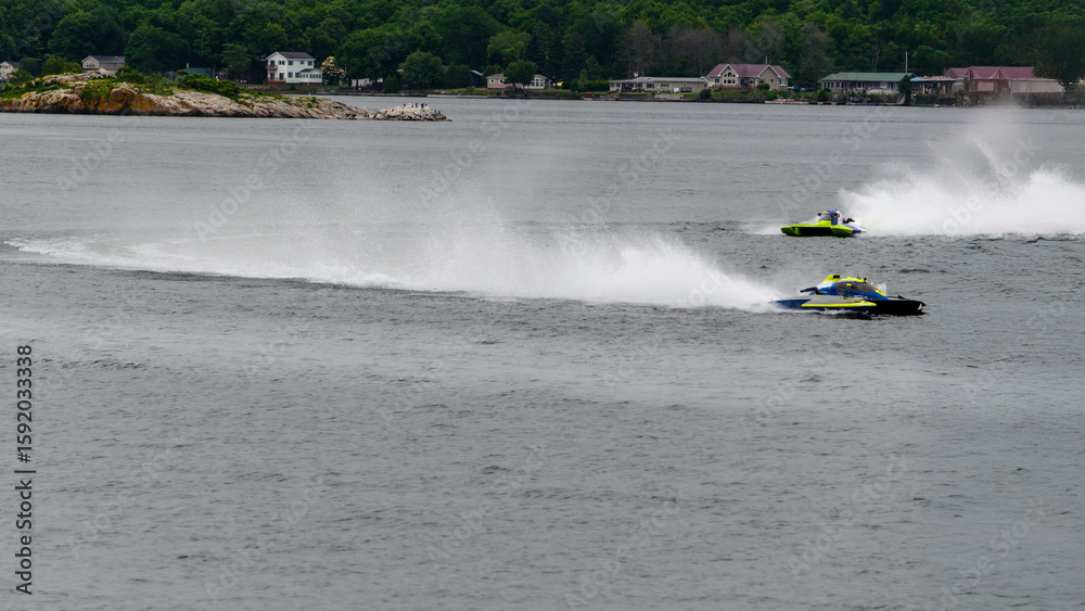 Fototapeta premium Two hydroplane racing boats going in opposite directions during a race