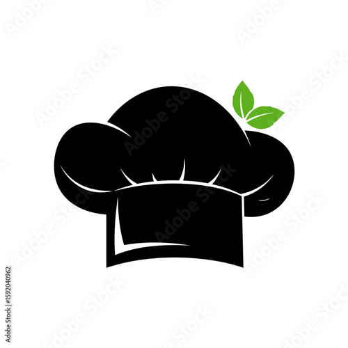 Black chef hat with basil leaf on white background with copy space