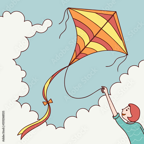 A person flying a kite in a blue sky with white clouds and the kite has yellow and orange stripes design
