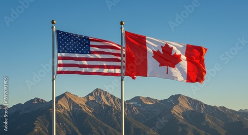 United States and Canada flags wave proudly with picturesque mountain backdrop beneath a clear
