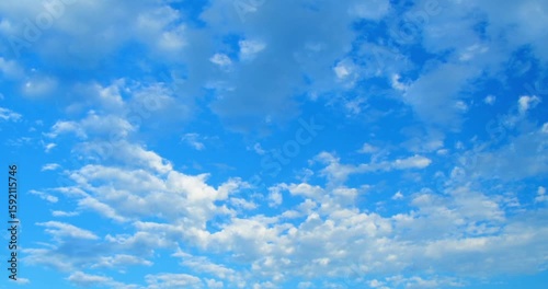 Timelapse of clouds moving in the blue sky.