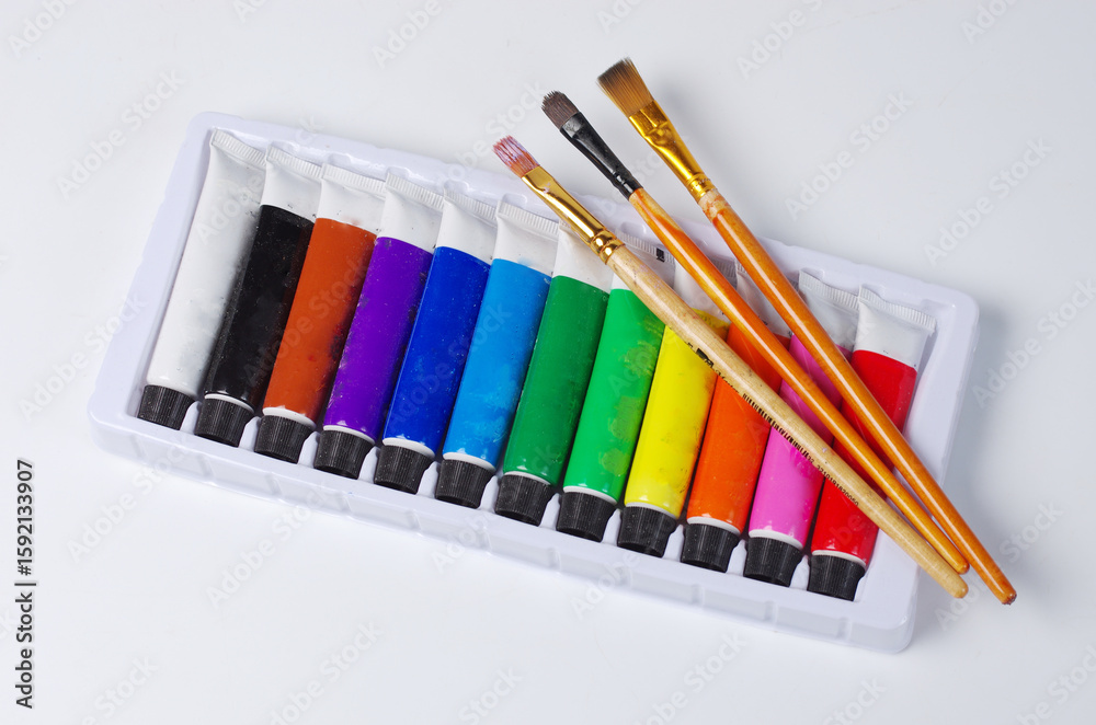 Obraz premium A set of oil paints for painting and three art brushes.