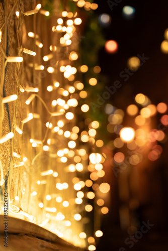 Strings of glowing yellow fairy lights attached to a wall
