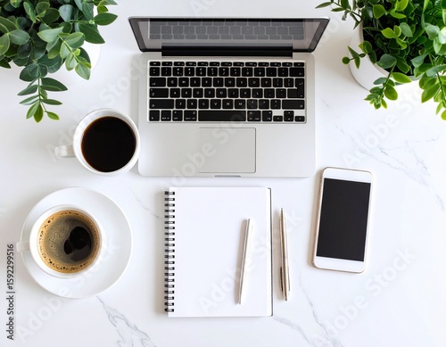 Flat Lay Workspace with Laptop, Smartphone, Coffee Mug, Notepad, and Plant on White Desk