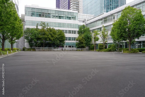 A large empty parking lot in front of the atrium building at Shibuya, Japan The asphalt surface is clean and smooth with no vehicles or people present Generative AI
