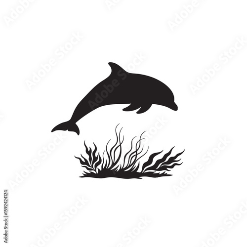 A leaping dolphin above the ocean floor vegetation in a black silhouette