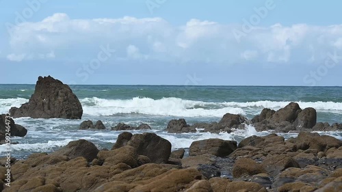 Danfer of surfing and swimming near rocks