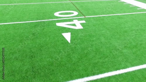 A closeup of a football fields forty yard line