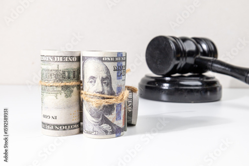 Legal Fine and Compensation Concept with Money Bundles and Gavel