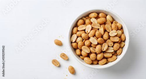 Peanut flips in a white ceramic bowl next to some peanut flips isolated on white. Top view.