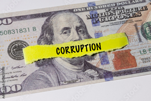 A note marked “Corruption” is set on a spread of cash, highlighting misuse of public funds and unethical financial practices.