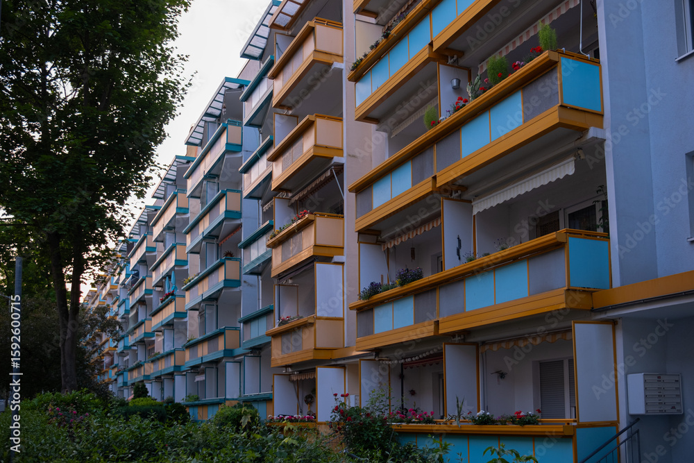 Obraz premium apartment building in a small town in Germany. Neat cozy balconies, front entrance, flowers near the entrance to the house