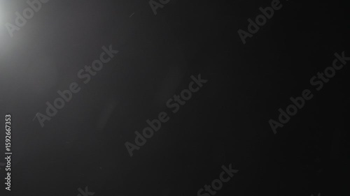 Wallpaper Mural A black and white photo of a dark room with a light shining on it. The photo has a moody and mysterious feel to it Torontodigital.ca