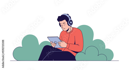 Man wearing headphones enjoying content on tablet while sitting outdoors amongst greenery