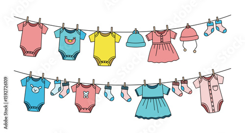 Cute baby clothes drying on a clothesline with clips and cute designs