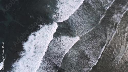 Wavy surface of sea or ocean. Big waves with white foam, splashing each other. Drone view, aerial shot. Chilling, relaxing atmosphere. Salty water, high tide concept