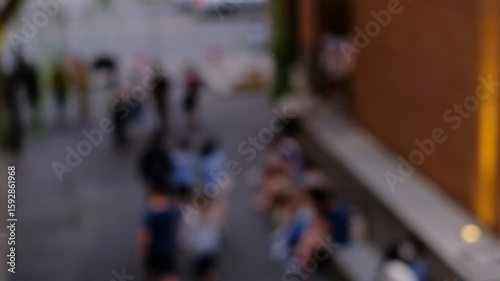 Wallpaper Mural A blurry image of a group of people walking down a street. Scene is somewhat chaotic, as the people are moving in different directions and the background is blurry Torontodigital.ca