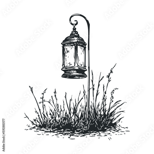 Vintage lantern with grass in a serene outdoor setting at dusk