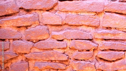 A Pink Stone Wall Made of Irregular Stone Blocks Mortared Together