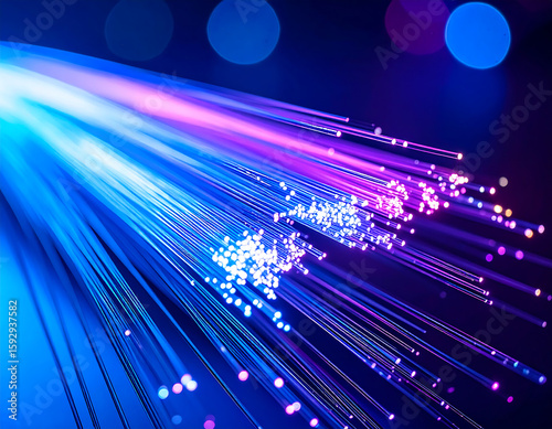 A close-up of illuminated fiber optic cables glowing with blue and purple light against a dark background.