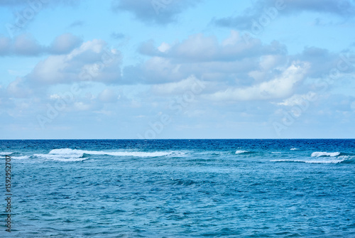 Blue Sky and Small Ocean Waves on the Horizon